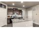 Updated kitchen featuring granite counters, dark cabinets, and stainless appliances, perfect for cooking and casual dining at 697 Gamble Oak St, Brighton, CO 80601
