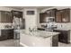 Modern kitchen featuring granite counters, stainless appliances, and a spacious center island for food preparation and entertaining at 697 Gamble Oak St, Brighton, CO 80601