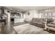 Open-concept living space that seamlessly integrates the living room, dining area, and kitchen at 697 Gamble Oak St, Brighton, CO 80601