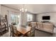 Open-concept living space featuring a dining area and a living room with a tv at 697 Gamble Oak St, Brighton, CO 80601