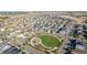 Expansive aerial view of a well-planned neighborhood, featuring mature trees, green spaces, and attractive single-Gathering homes at 697 Gamble Oak St, Brighton, CO 80601