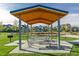 Park pavilion with picnic tables and a grill, providing a shaded space for outdoor gatherings and picnics at 697 Gamble Oak St, Brighton, CO 80601