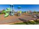Community playground with colorful play structures, slides, and climbing areas for entertainment at 697 Gamble Oak St, Brighton, CO 80601