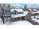 A winter aerial view of a charming two-story home with a large, snow-covered yard at 982 E 130Th Cir, Thornton, CO 80241