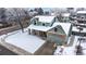 Aerial view of a two-story home with a large, snow-covered yard and neighborhood at 982 E 130Th Cir, Thornton, CO 80241