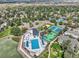 An aerial view of the community pool, tennis court, sand volleyball court, and lake on a sunny day at 982 E 130Th Cir, Thornton, CO 80241