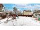 Snowy backyard featuring a wooden playset, a small shed, and a privacy fence at 982 E 130Th Cir, Thornton, CO 80241