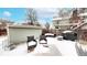 Snowy backyard patio area featuring outdoor seating, a grill, and a storage shed at 982 E 130Th Cir, Thornton, CO 80241