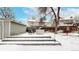 An elevated patio area with seating adds charm to this home's backyard at 982 E 130Th Cir, Thornton, CO 80241