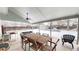 Covered backyard patio with ceiling fan, grill, and a picnic table at 982 E 130Th Cir, Thornton, CO 80241