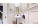 Elegant powder room featuring decorative mirror and classic pedestal sink at 982 E 130Th Cir, Thornton, CO 80241