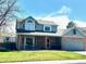 Charming two-story home with brick accents, a covered porch and well-maintained front lawn at 982 E 130Th Cir, Thornton, CO 80241
