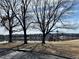 Neighborhood lake with a bench overlooking the water and a walking path at 982 E 130Th Cir, Thornton, CO 80241