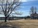 Scenic view of a tranquil lake with walking path, framed by trees and blue skies at 982 E 130Th Cir, Thornton, CO 80241