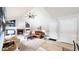 Inviting living room with a vaulted ceiling, brick fireplace, and built-in shelving at 982 E 130Th Cir, Thornton, CO 80241