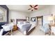 Bright main bedroom featuring a large bed, stylish furnishings, and ensuite bathroom access at 982 E 130Th Cir, Thornton, CO 80241