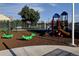 Community playground with swings, slides, and fun animal themed spring riders at 982 E 130Th Cir, Thornton, CO 80241