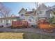 Rear exterior view of a residence with a deck and landscaped backyard at 5960 S Jellison St # B, Littleton, CO 80123