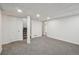 Unfinished basement with stairs, neutral carpet, and white walls at 5960 S Jellison St # B, Littleton, CO 80123