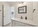 Bright bathroom featuring a white vanity, modern fixtures, and a framed mirror over the sink at 5960 S Jellison St # B, Littleton, CO 80123