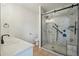 Remodeled bathroom featuring marble shower, glass doors, modern fixtures, white vanity and toilet at 5960 S Jellison St # B, Littleton, CO 80123