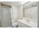 Bathroom with shower, white vanity, and neutral finishes at 5960 S Jellison St # B, Littleton, CO 80123