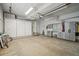 Organized garage featuring storage solutions, tool racks, and a clean floor at 5960 S Jellison St # B, Littleton, CO 80123