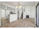 Bright open-concept living area with hardwood floors, fireplace, and updated kitchen featuring stainless steel appliances at 5960 S Jellison St # B, Littleton, CO 80123