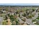 Wide aerial shot of a residential neighborhood with a clear view of the cityscape in the background at 1359 S Brentwood Way, Lakewood, CO 80232