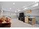 Finished basement with carpet and a granite-topped bar featuring a beverage refrigerator and plenty of room to entertain at 1359 S Brentwood Way, Lakewood, CO 80232