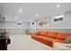 Finished basement featuring plush carpeting, recessed lighting, and a comfortable orange couch at 1359 S Brentwood Way, Lakewood, CO 80232