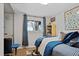 Cozy bedroom with hardwood floors, a large window, and a comfortable bed at 1359 S Brentwood Way, Lakewood, CO 80232