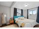 Bright bedroom featuring hardwood floors and a comfortable bed with throw pillows at 1359 S Brentwood Way, Lakewood, CO 80232