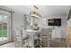 Bright dining area featuring a rustic chandelier, a large table with chairs, and hardwood floors at 1359 S Brentwood Way, Lakewood, CO 80232
