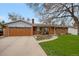 Charming single-story home with a brick facade, a well-manicured lawn, and a welcoming front yard garden at 1359 S Brentwood Way, Lakewood, CO 80232