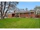 Attractive single-Gathering home featuring a brick exterior, a spacious front yard, and a two-car garage at 1359 S Brentwood Way, Lakewood, CO 80232