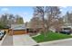 Charming single-story home with a well-maintained lawn, mature trees, and an attached two-car garage at 1359 S Brentwood Way, Lakewood, CO 80232