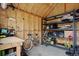 Organized garage interior with storage shelves, workbench, and a bicycle for convenient home maintenance and hobbies at 1359 S Brentwood Way, Lakewood, CO 80232