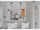 Open kitchen view showcasing modern lighting and bar seating with a beautiful granite countertop at 1359 S Brentwood Way, Lakewood, CO 80232