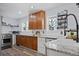 Updated kitchen featuring stainless steel appliances, granite countertops, and wood and white cabinets at 1359 S Brentwood Way, Lakewood, CO 80232