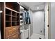 Basement closet area with a shelving unit, hanging clothes, and a modern washer and dryer at 1359 S Brentwood Way, Lakewood, CO 80232
