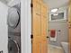 Bright laundry room area featuring a stackable washer and dryer unit, a new light and a storage cabinet at 1359 S Brentwood Way, Lakewood, CO 80232
