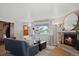 Living room features a stone fireplace, large window, and stylish decor, creating a warm and inviting space at 1359 S Brentwood Way, Lakewood, CO 80232