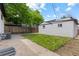 A fenced backyard features a detached painted garage and lawn area at 1845 W 39Th Ave, Denver, CO 80211