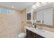 Elegant bathroom featuring tiled shower, vanity with sink, and decorative accents at 1845 W 39Th Ave, Denver, CO 80211