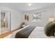 Bright bedroom features hardwood floors, a cozy chair and lots of natural light at 1845 W 39Th Ave, Denver, CO 80211