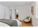 Comfortable bedroom with hardwood floors, a cozy chair and an ensuite bathroom at 1845 W 39Th Ave, Denver, CO 80211