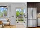 Modern kitchen with stainless steel refrigerator and a view to the front porch at 1845 W 39Th Ave, Denver, CO 80211