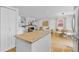 Open-concept kitchen with stainless steel appliances, dark wood cabinets, and an island at 1845 W 39Th Ave, Denver, CO 80211
