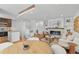 Open-concept living space with stone fireplace, hardwood floors, kitchen view, and modern furnishings at 1845 W 39Th Ave, Denver, CO 80211